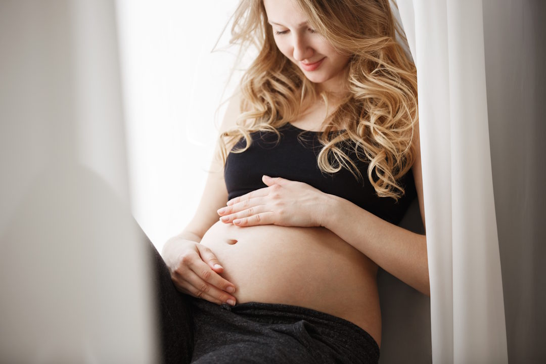 Une femme enceinte qui touche son ventre