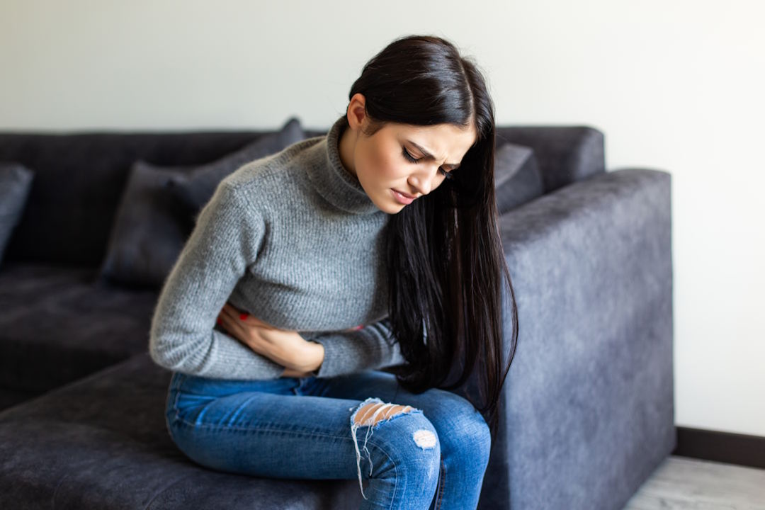 Une femme qui a une douleur abdominale intense