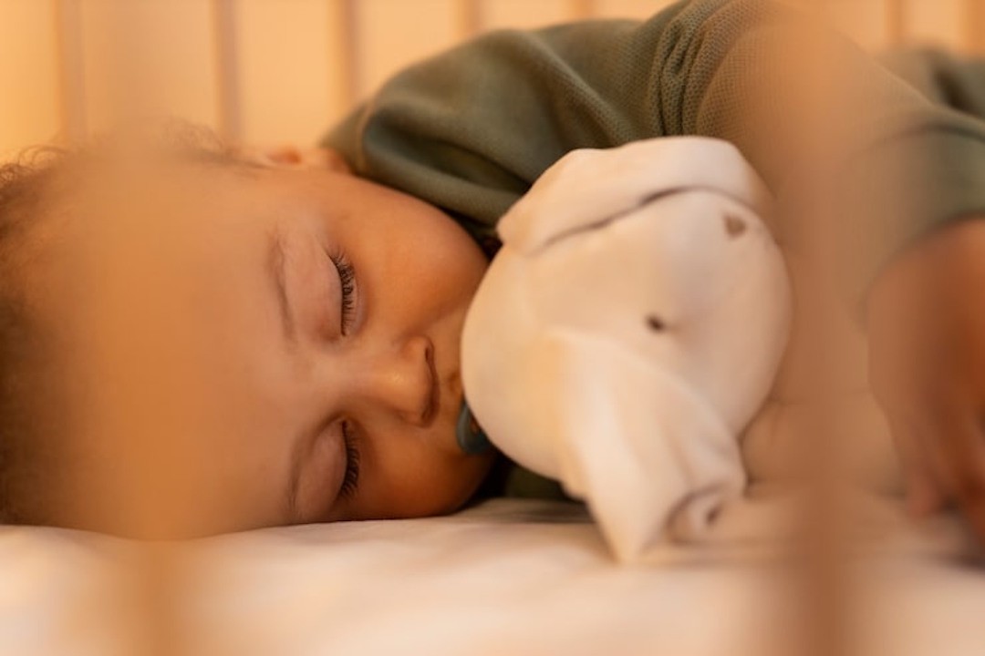 Un bébé qui dort bien avec son doudou